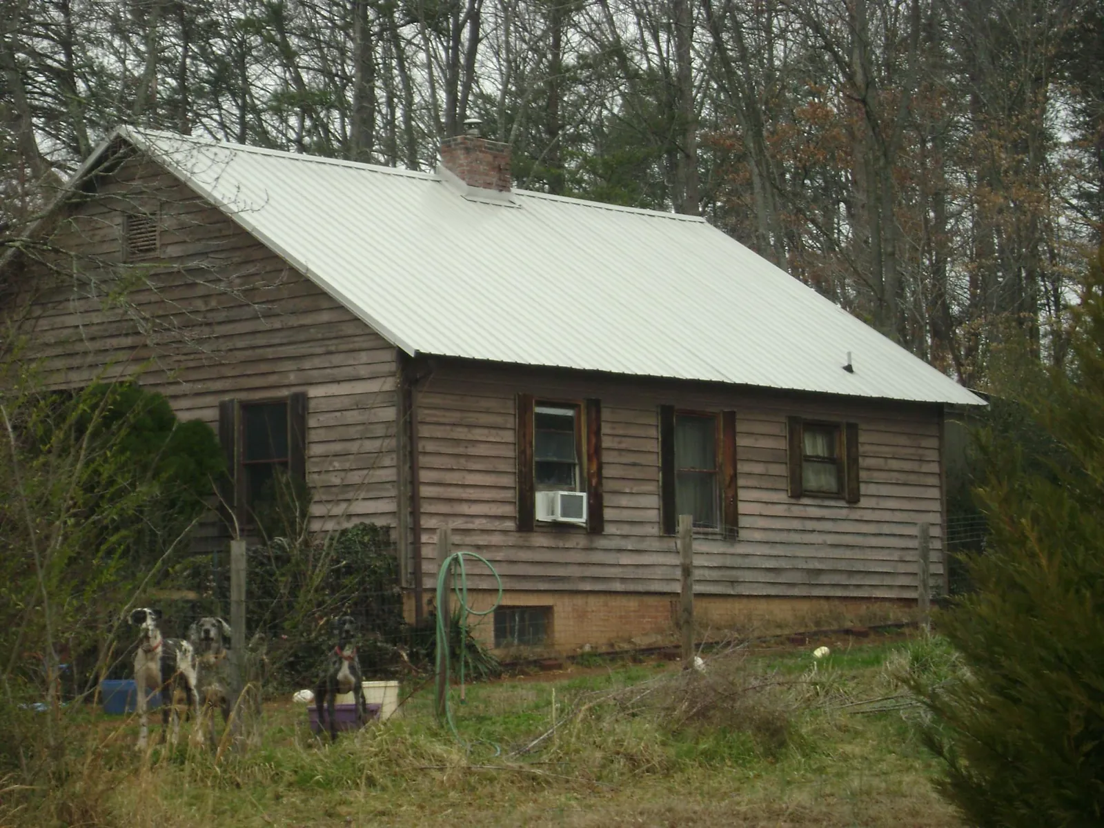 White metal roof on an old wood sided farmhouse, from a Metal Roof Installation job in Brooktondale